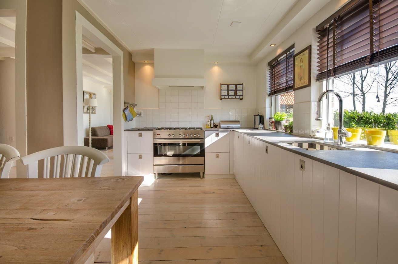 a kitchen with wooden cabinets and a dining table