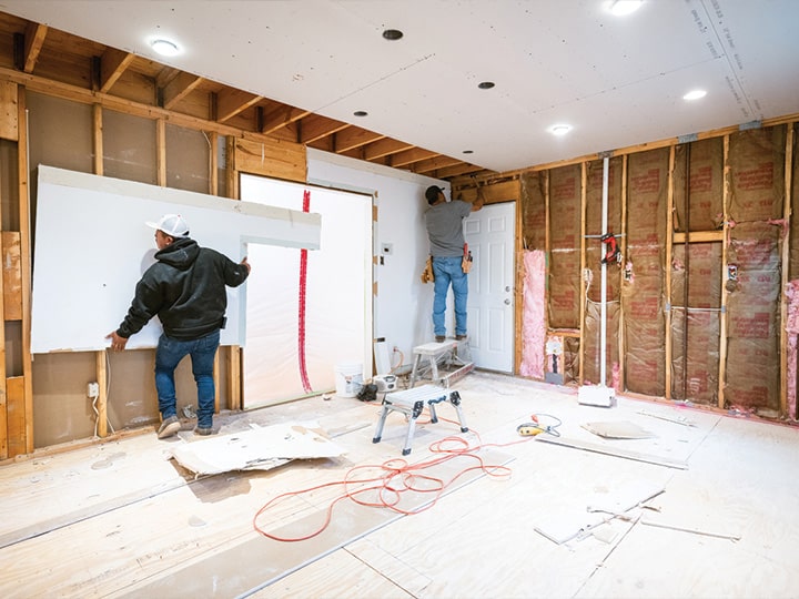two workers doing reconstruction work