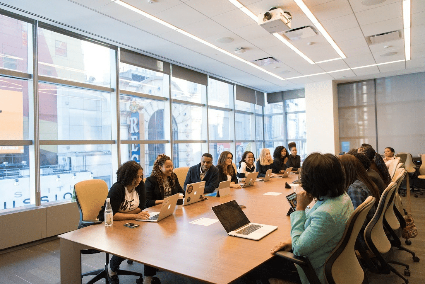 a group of people sitting at a table in a conference room