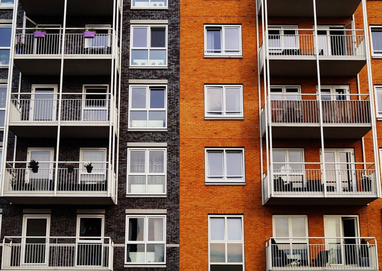 a large brick building with windows and balconies